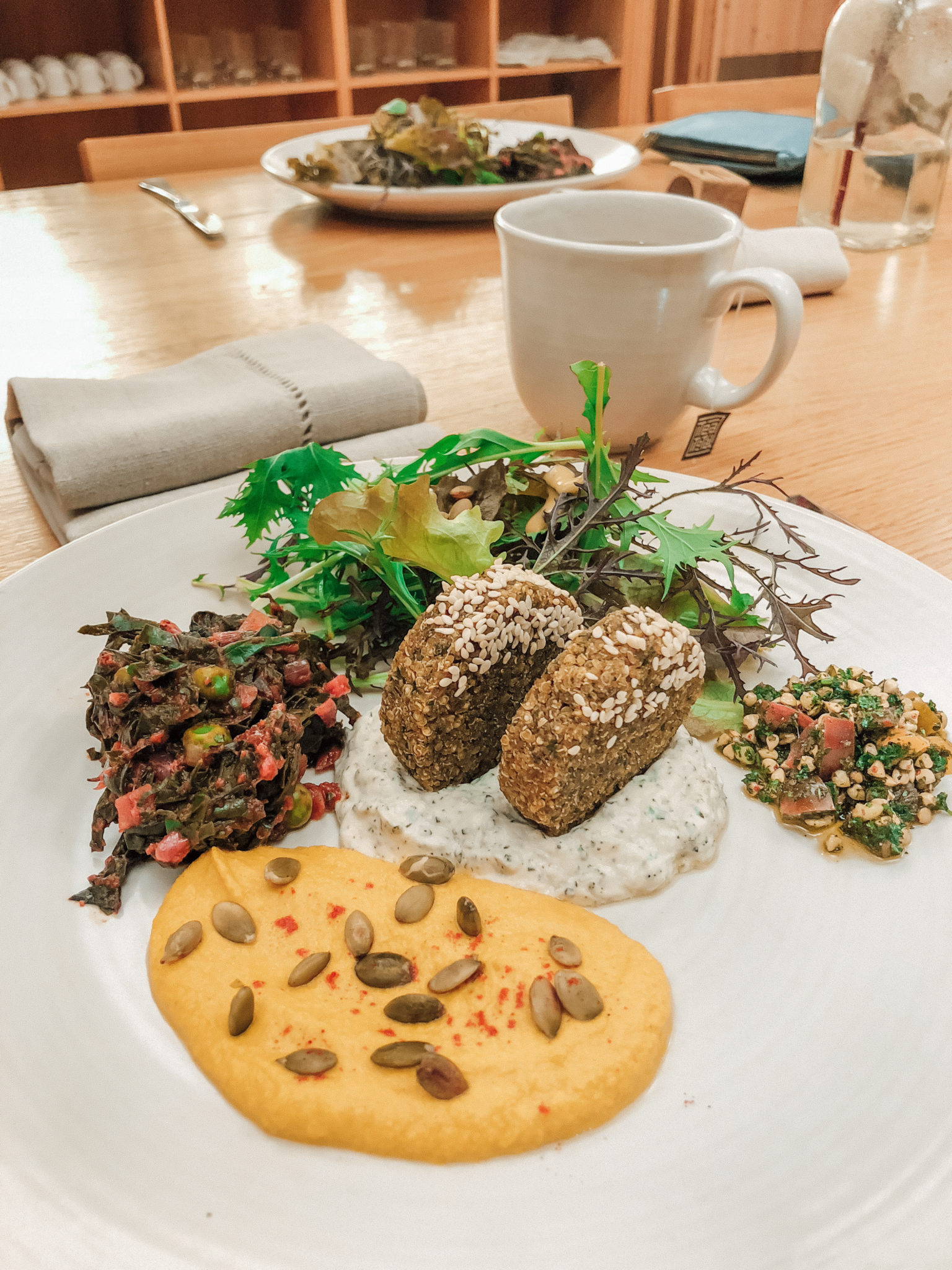 Plant-based patties with pumpkin dip and greens at Aro Hā